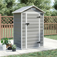 Closed 4x3ft grey plastic tool shed placed on white patio floor against garden fence – neat backyard storage solution