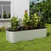 Galvanized silver oval-shaped raised garden bed in backyard garden – perfect for growing plants and herbs outdoors