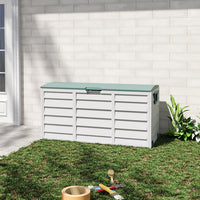 Green and light grey outdoor deck box placed against garden wall – 290L storage for patio essentials