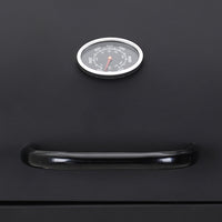 Close-up of side prep panels and temperature gauge on garden charcoal BBQ grill – convenient design for outdoor cooking preparation