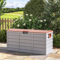brown garden storage box with wheels – closed and placed against garden wall, perfect for patio storage