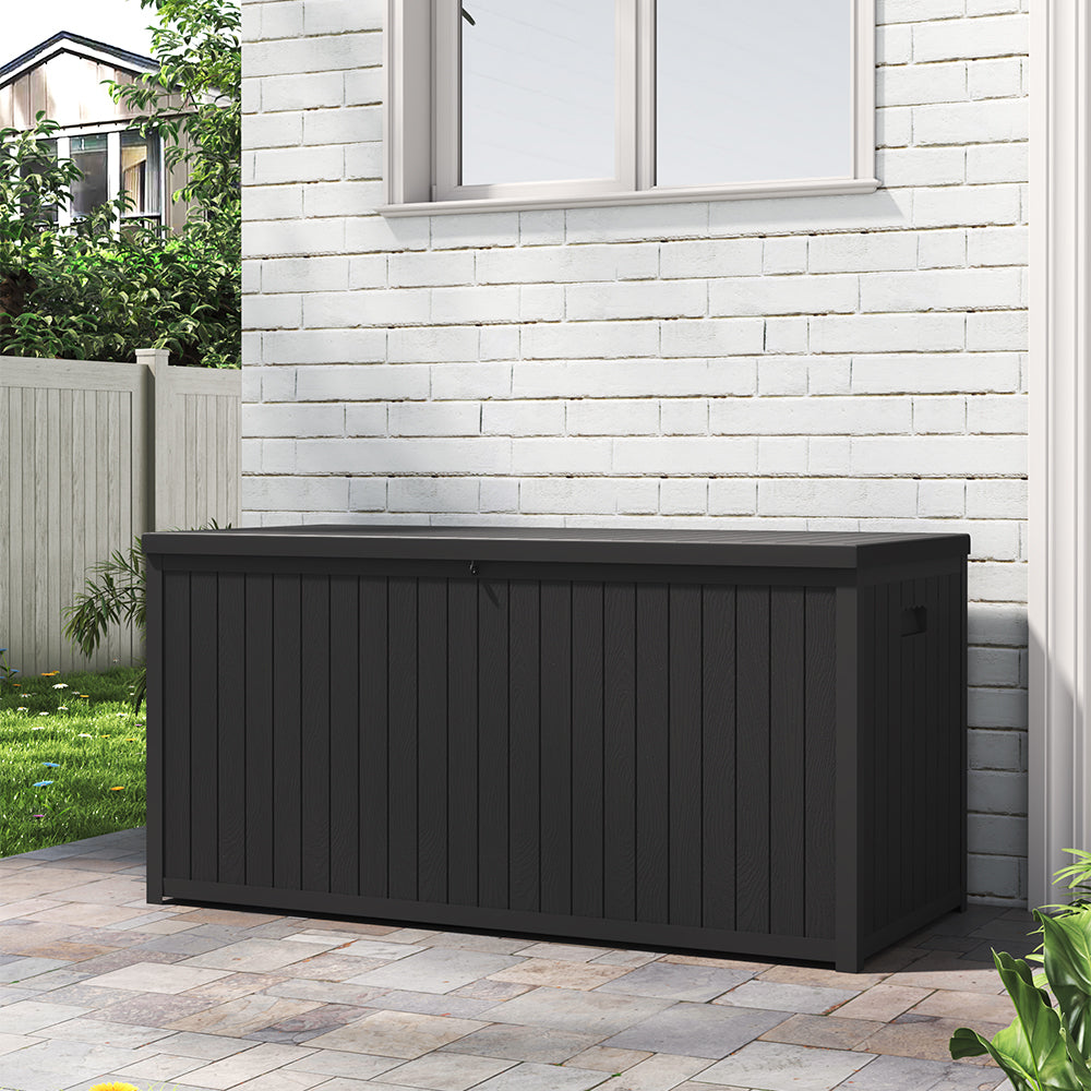 Weatherproof Black 430L Storage Box Against Patio Wall – Ideal for Garden Use