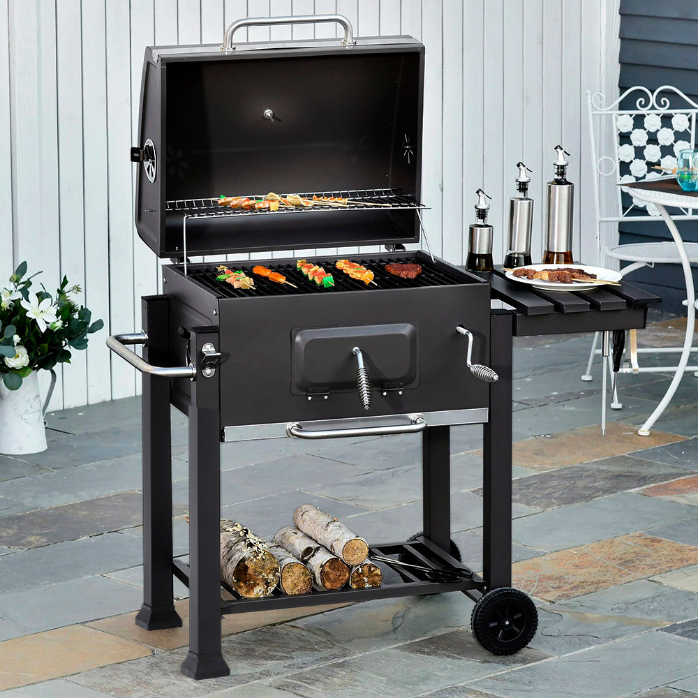 large outdoor BBQ grill in use on patio – charcoal grill with food cooking for garden event