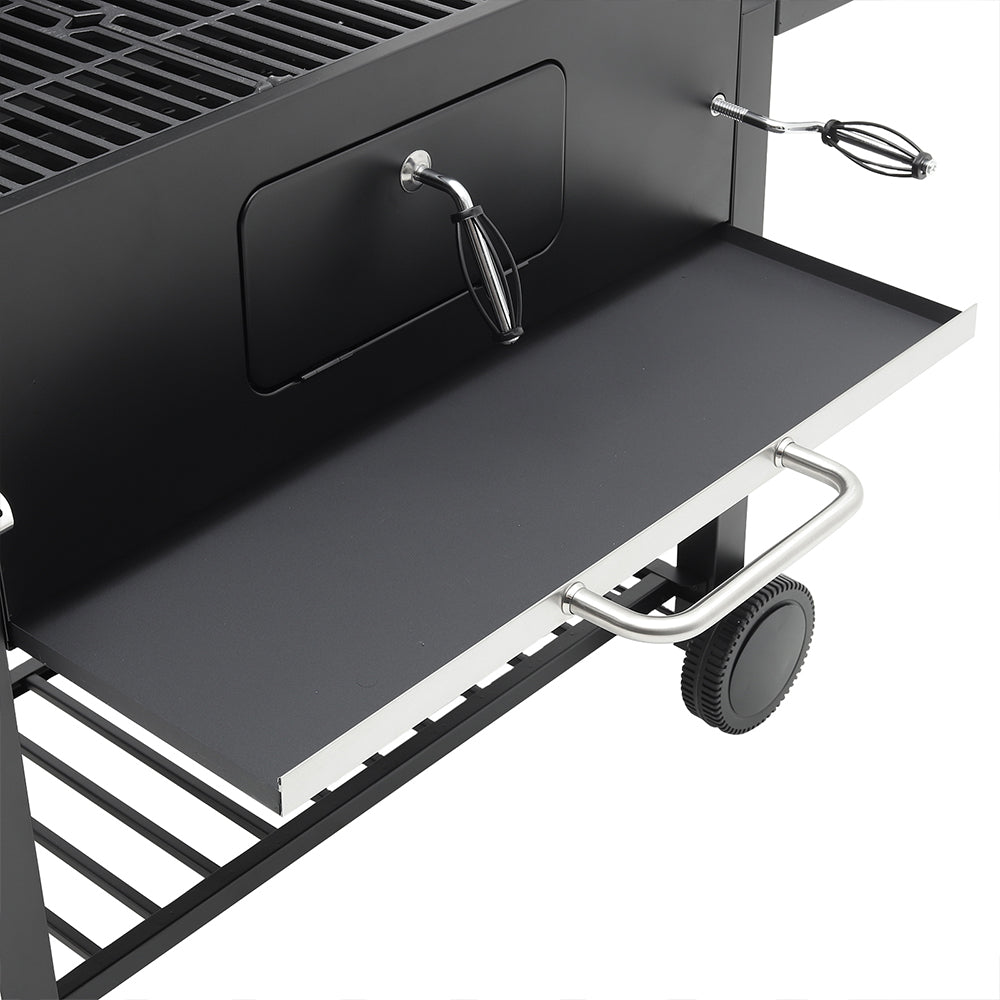 Pull-out storage tray below charcoal BBQ grill’s air vent – convenient ash catcher and storage space