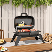 Tabletop Charcoal BBQ Grill in Use – Perfect for Garden Barbecues and Outdoor Picnics