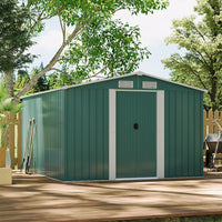 Spacious green metal shed in home garden used for outdoor storage