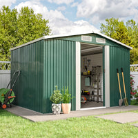 Open green garden shed with tools neatly stored inside, set against garden fence on patio