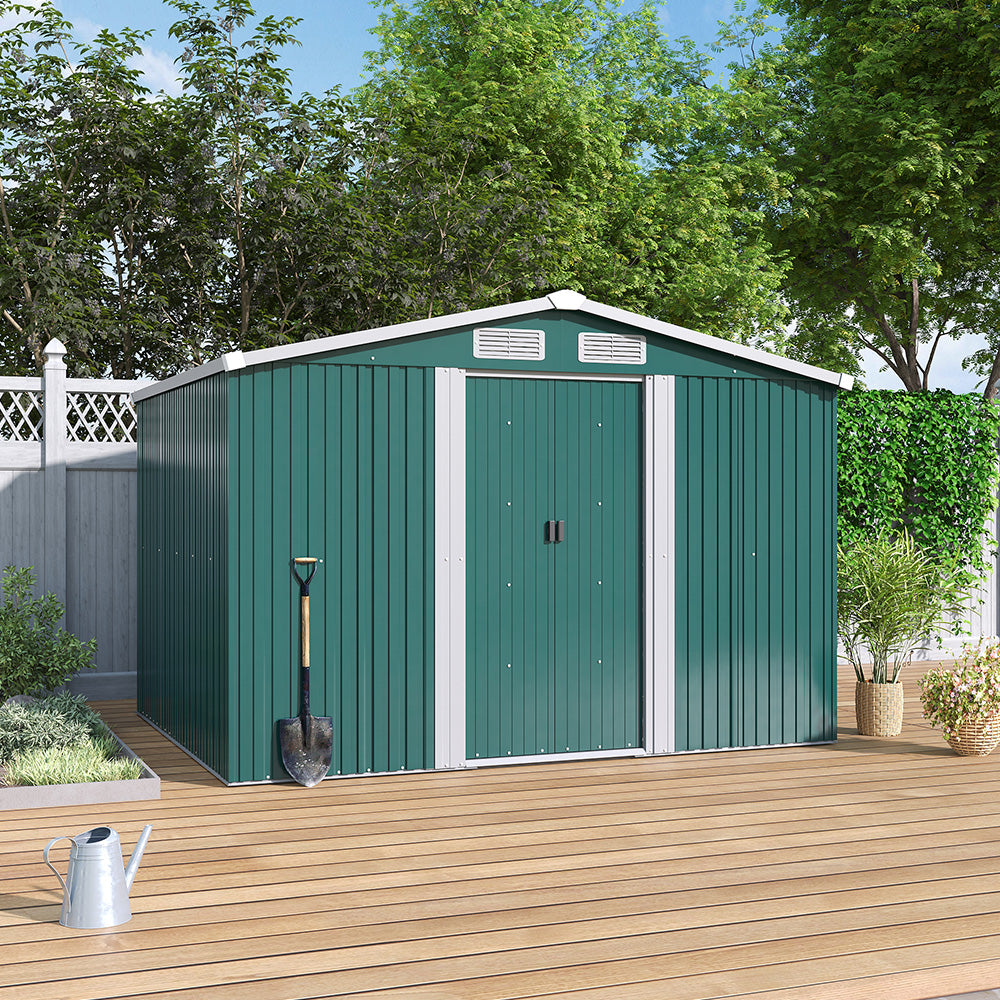 Green 6x8ft garden shed placed on wooden patio floor, closed doors, against backyard fence