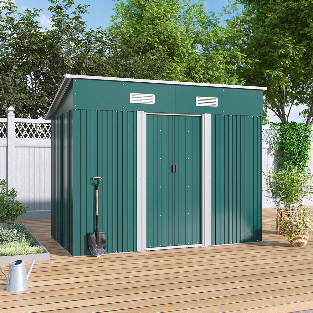 closed green garden shed placed on wooden deck against backyard fence - outdoor setting
