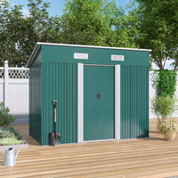 closed green garden shed placed on wooden deck against backyard fence - outdoor setting