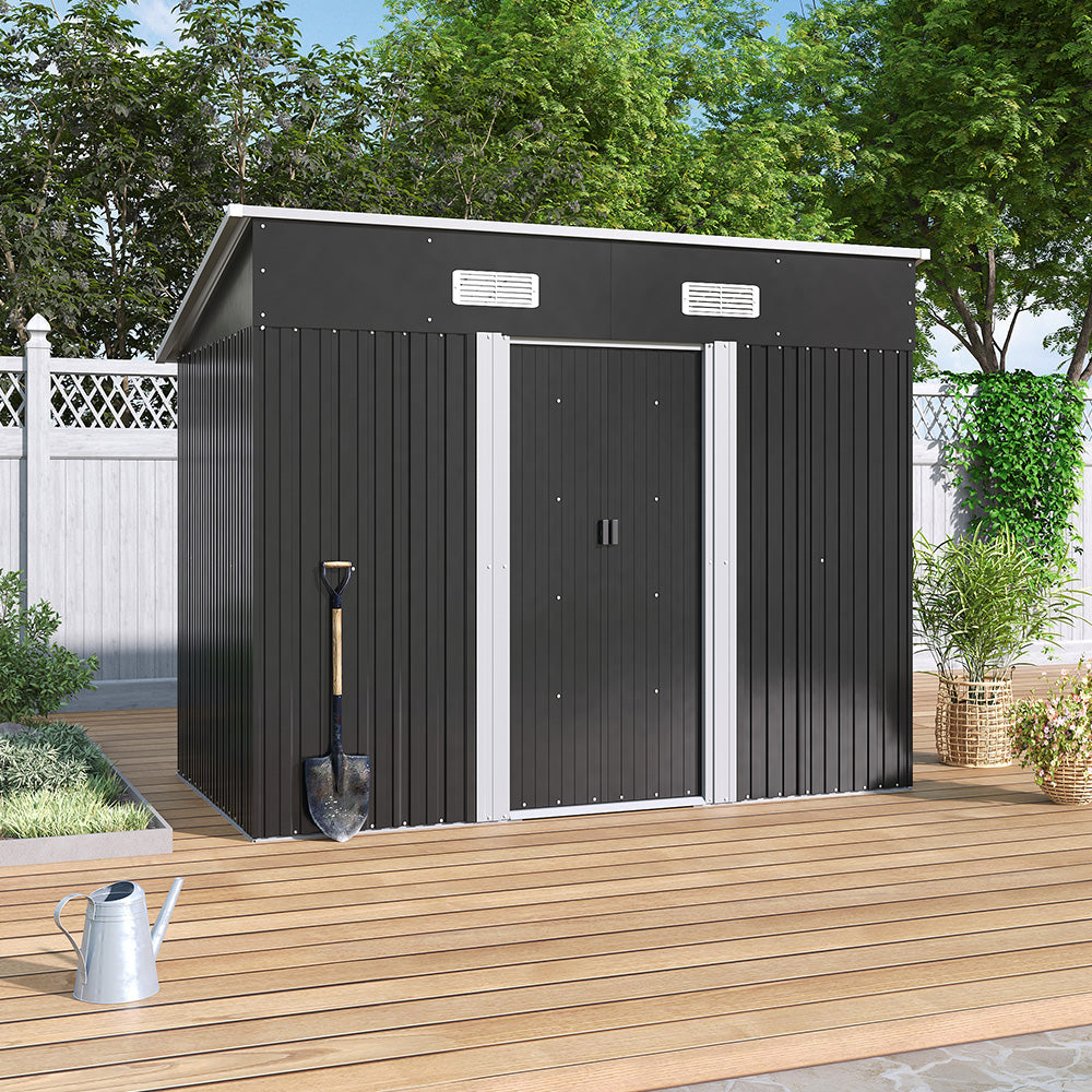 closed black garden shed on wooden deck beside backyard fence - patio scene