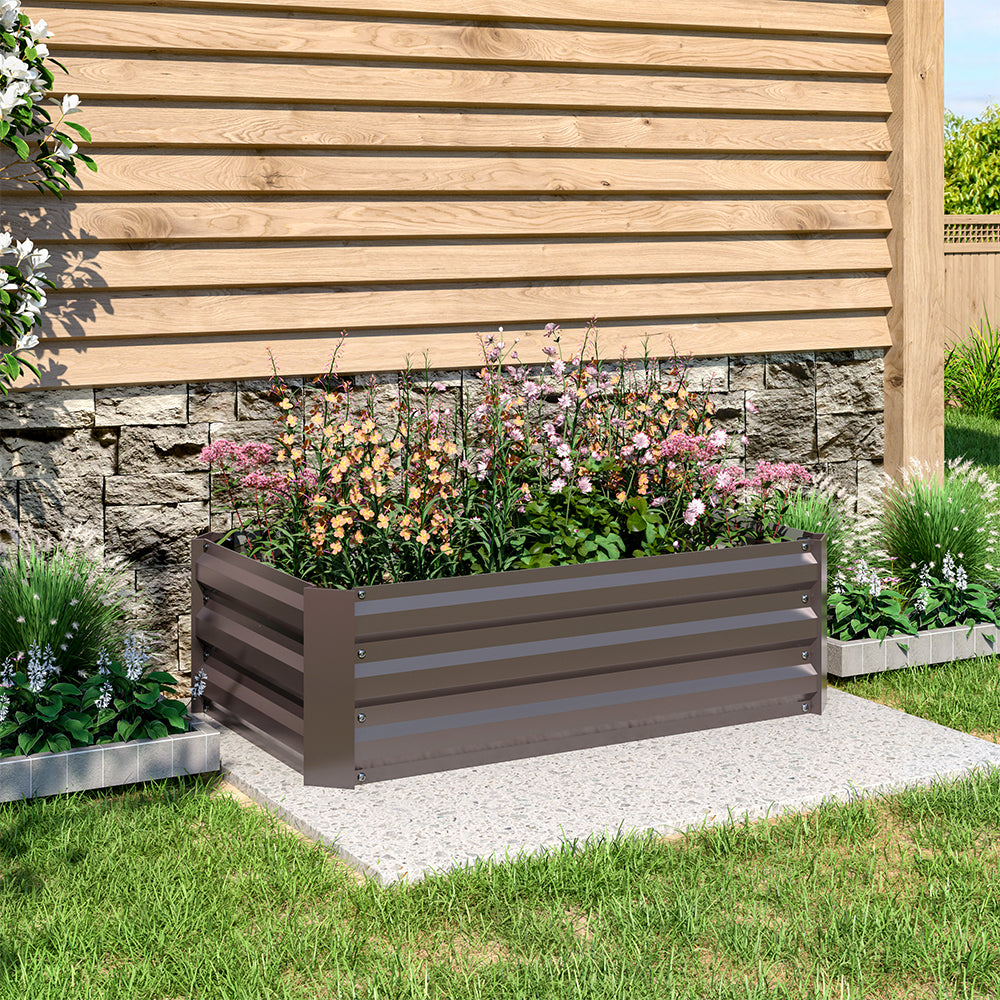 Brown Galvanized Steel Square Raised Garden Bed, 100cm W x 100cm D x 30cm H in a backyard garden with a variety of plants