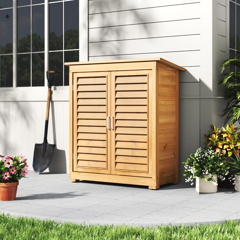 Closed 3x2ft Wooden Garden Cabinet Positioned Against House Wall – Neat Weatherproof Outdoor Storage Solution