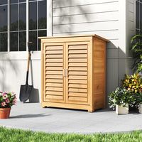 Closed 3x2ft Wooden Garden Cabinet Positioned Against House Wall – Neat Weatherproof Outdoor Storage Solution