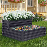 Outdoor Double-Layer Rectangular Metal Raised Garden Bed filled with thriving plants in a backyard garden