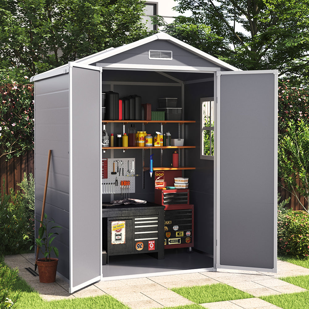 backyard scene showing 6x4ft grey garden shed with open door storing garden tools and equipment