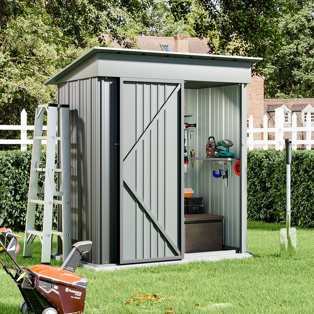 backyard setup showing 5x3ft grey garden shed with open door, storing tools and garden equipment