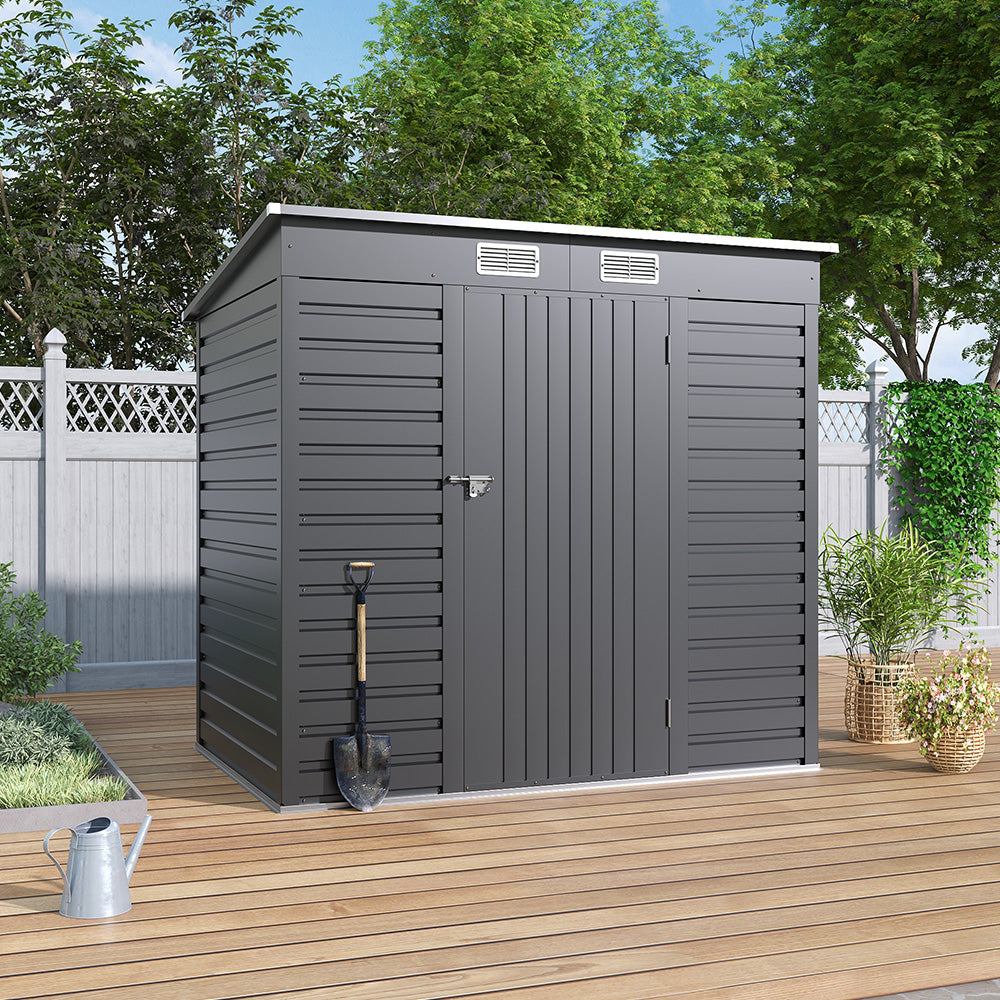 Closed 6x4ft metal garden shed on patio floor near wooden fence – compact and practical garden storage solution
