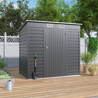 Closed 6x4ft metal garden shed on patio floor near wooden fence – compact and practical garden storage solution