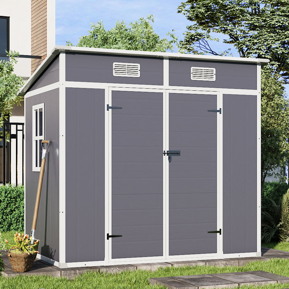 light grey 6x4ft plastic garden tool shed with closed doors placed in backyard setting