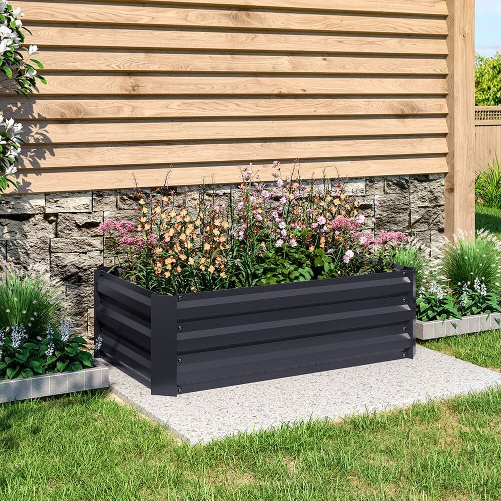 Small Black Galvanized Steel Square Raised Garden Bed in a garden filled with colorful plants and flowers