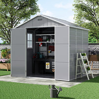 Angled view of 8x6ft plastic garden shed with window and open doors – bright interior with tool storage inside