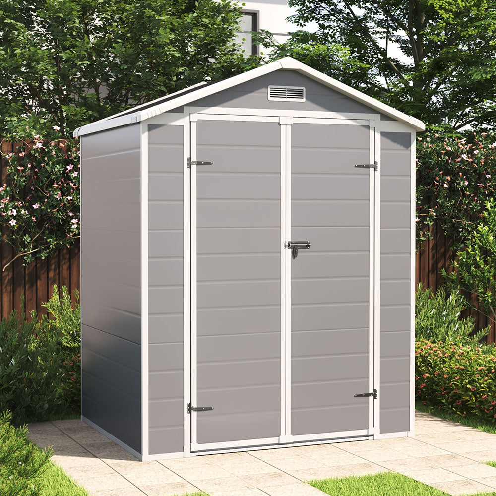6x4ft grey plastic outdoor shed placed in garden with closed double doors, ideal for yard storage