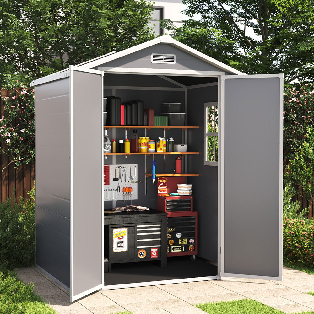 garden scene showing 6x4ft grey plastic shed with open doors storing tools and outdoor equipment