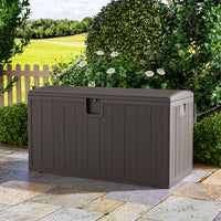 Brown rattan deck box in outdoor space – 127x61x63.5cm lockable garden storage box